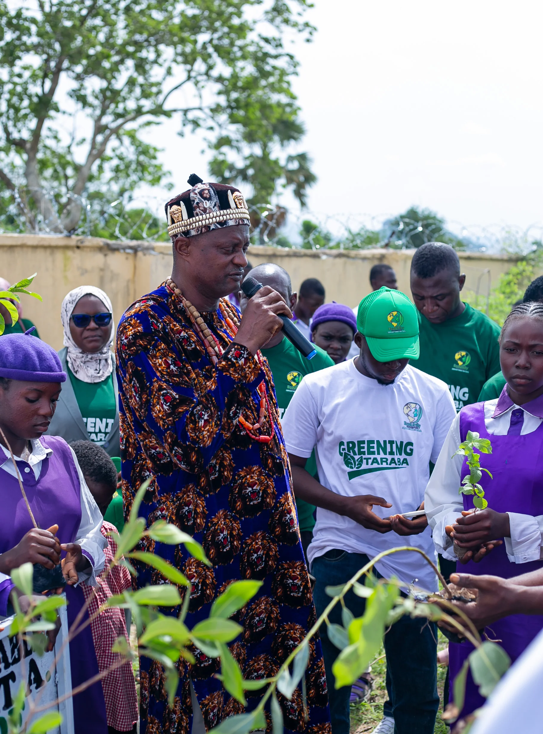 Young African people planting trees together in a community environmental project